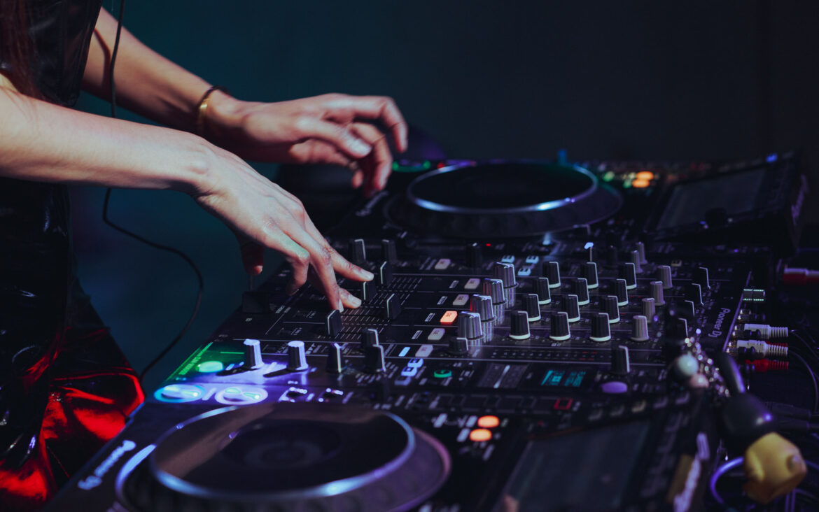 DJ using a mixing console; illustrative image, not Daria Kolosova, Djrum or an ADE session.