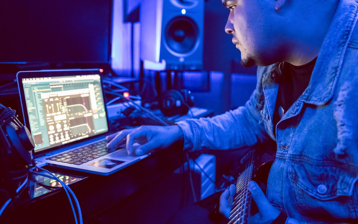 Music producer working in a studio; illustrative image, not BAMBII or an ADE participant.